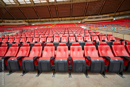 Rows of red armchairs at stadium