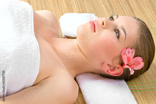 Facial skincare. Lovely young woman relaxing in spa salon