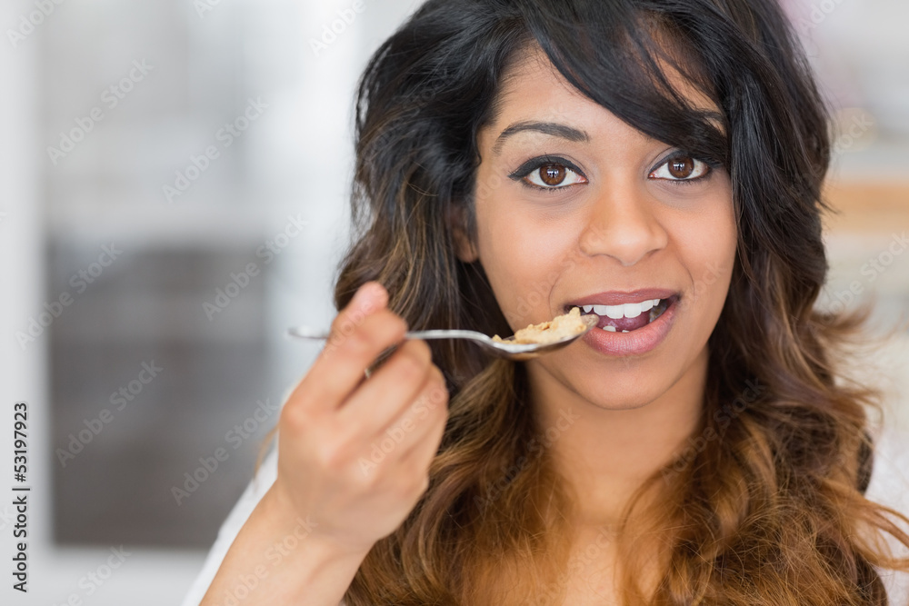 Fototapeta premium Woman holding a spoon with cereal
