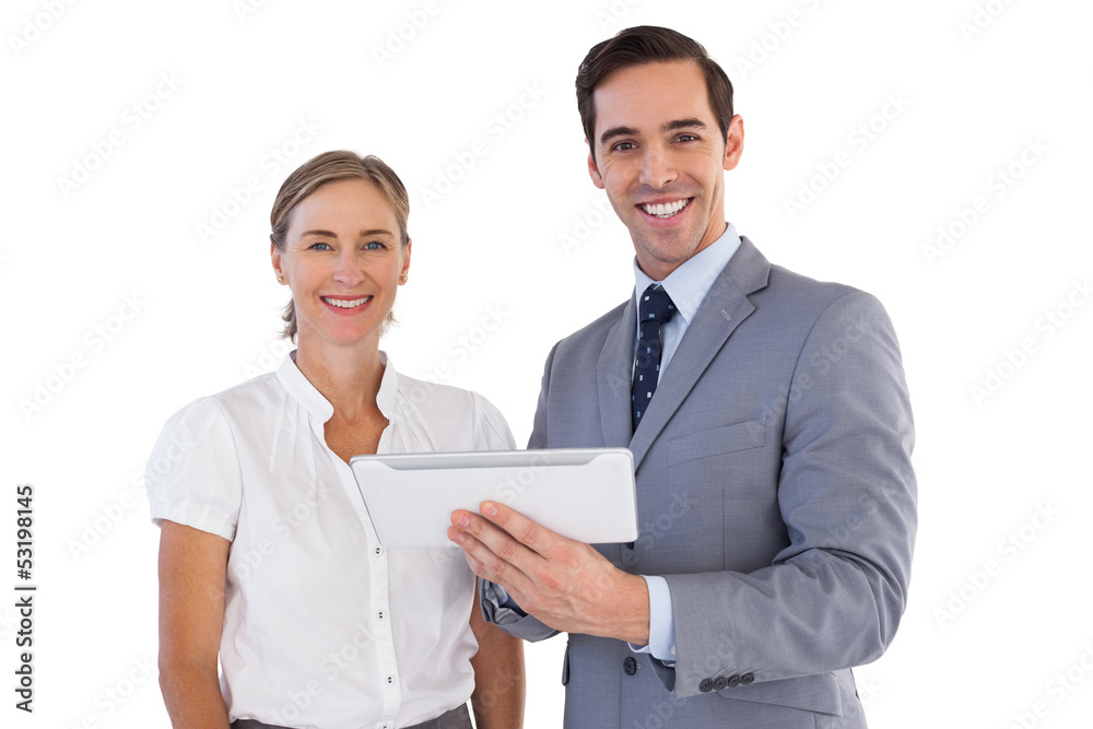 Smiling co workers using a tablet pc Smiling co workers using a tablet pc