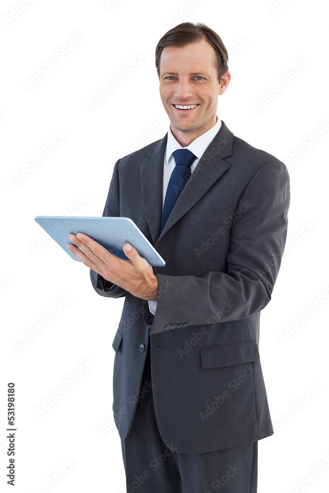 Smiling businessman holding a tablet computer