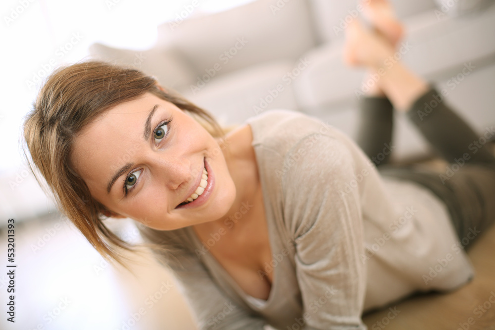 Smiling girl relaxing on the floor at home Smiling girl relaxing on the floor at home