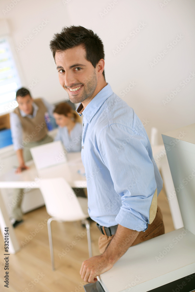 © goodluz - Smiling successful man standing in office © goodluz - Smiling successful man standing in office