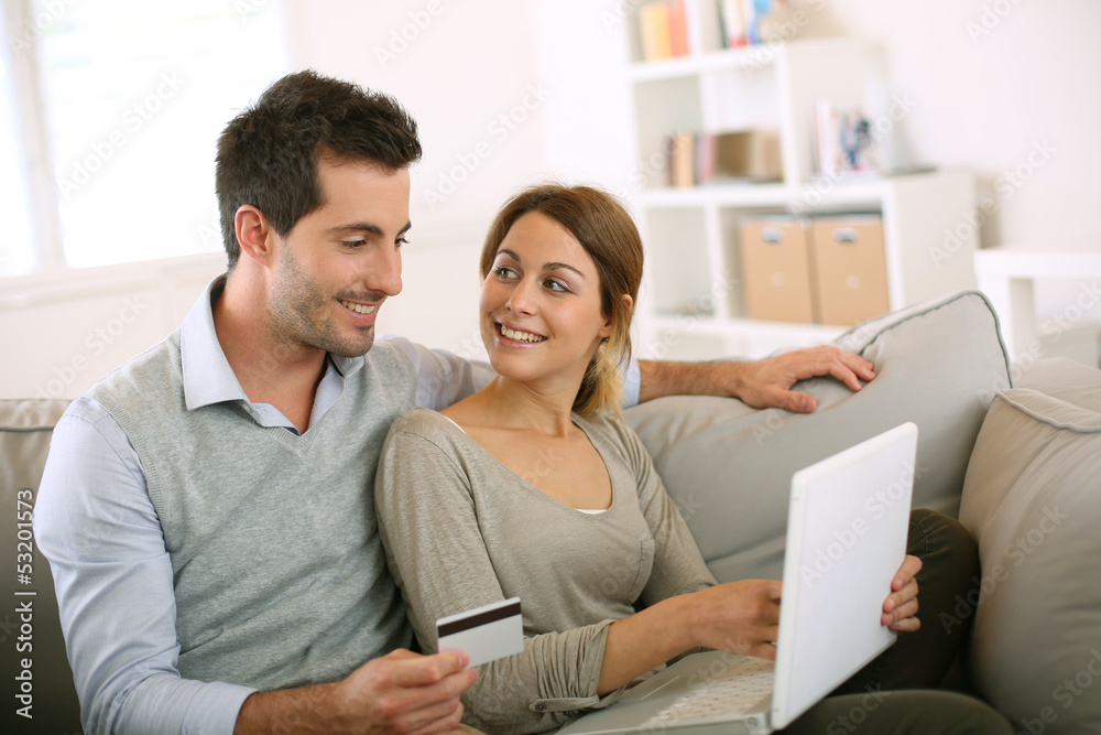 Couple using credit card to shop on internet Couple using credit card to shop on internet