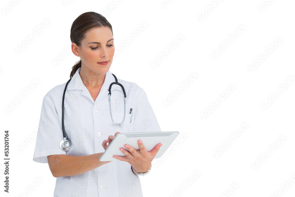 Happy nurse working on her tablet Happy nurse working on her tablet