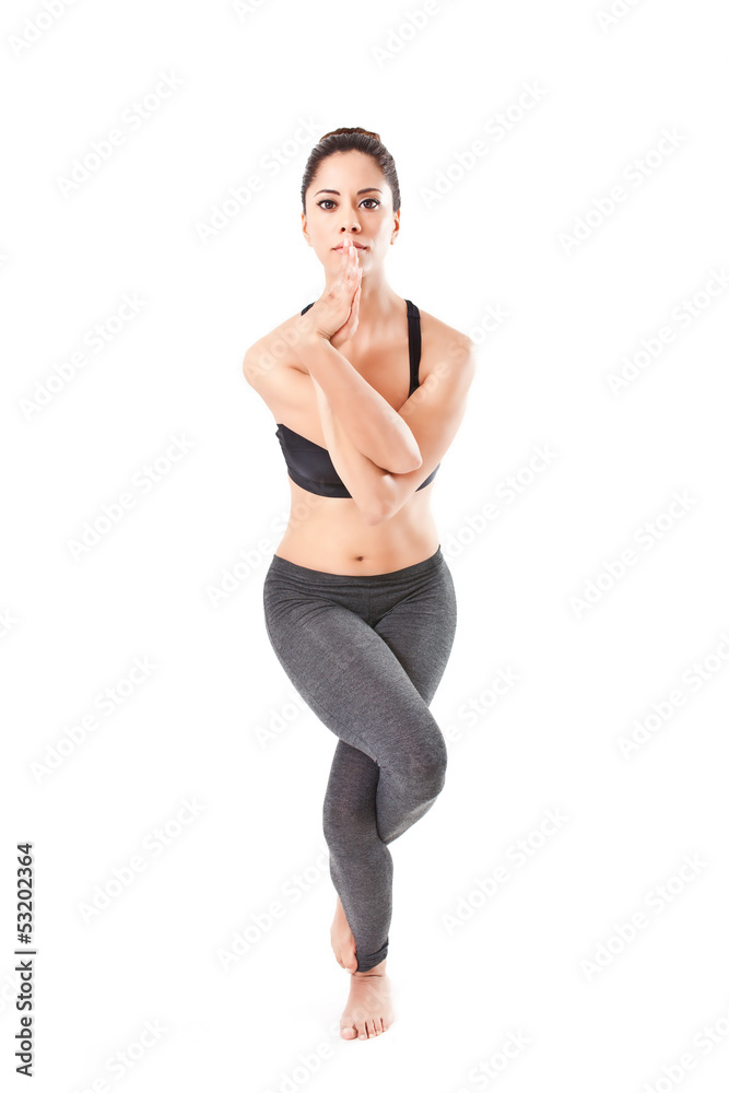 woman making a Yoga pose: Eagle Pose – Garurasana