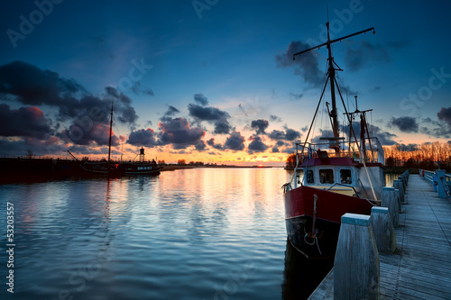 fishing ships at sunset in ...