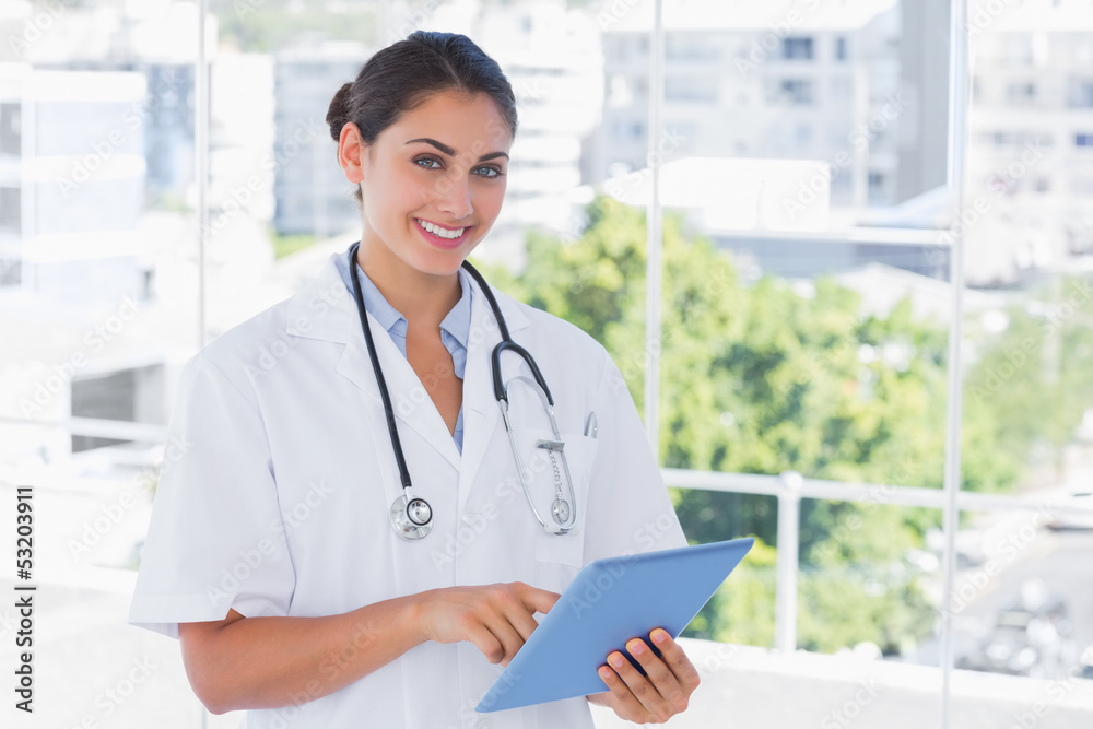 Happy young doctor using tablet pc Happy young doctor using tablet pc