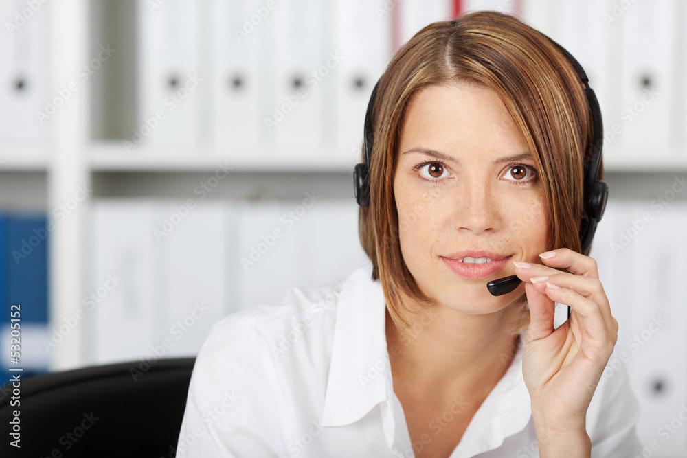 Confident businesswoman talking on headset Confident businesswoman talking on headset