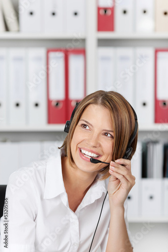 Laughing businesswoman talking on headset photo