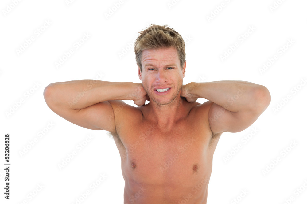Shirtless man yelling and suffering from neck pain Shirtless man yelling and suffering from neck pain