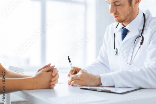 patient and doctor taking notes photo