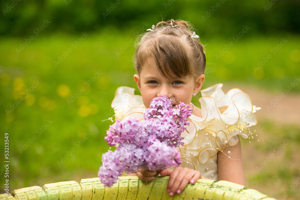 Portrait of a little girl with a bouquet of lilacs Portrait of a little girl with a bouquet of lilacs