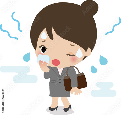 蒸し暑さで汗をかくスーツの女性