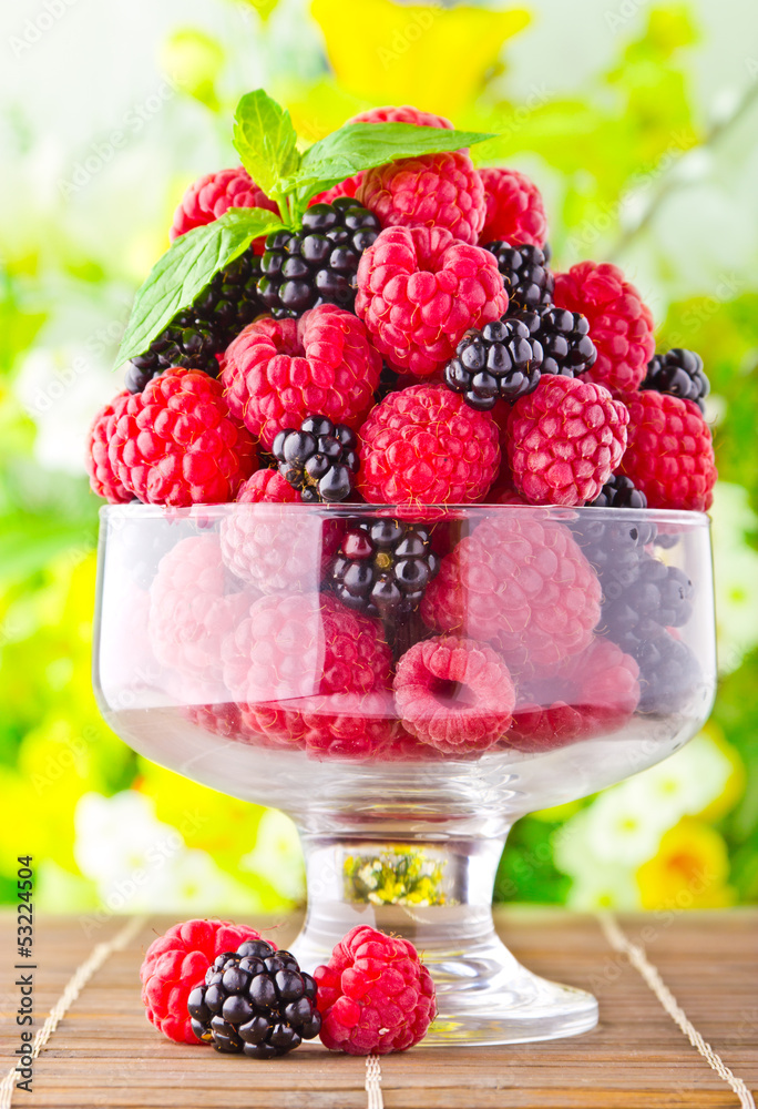 Sweet fresh fruits in glass goblet with mint leaf