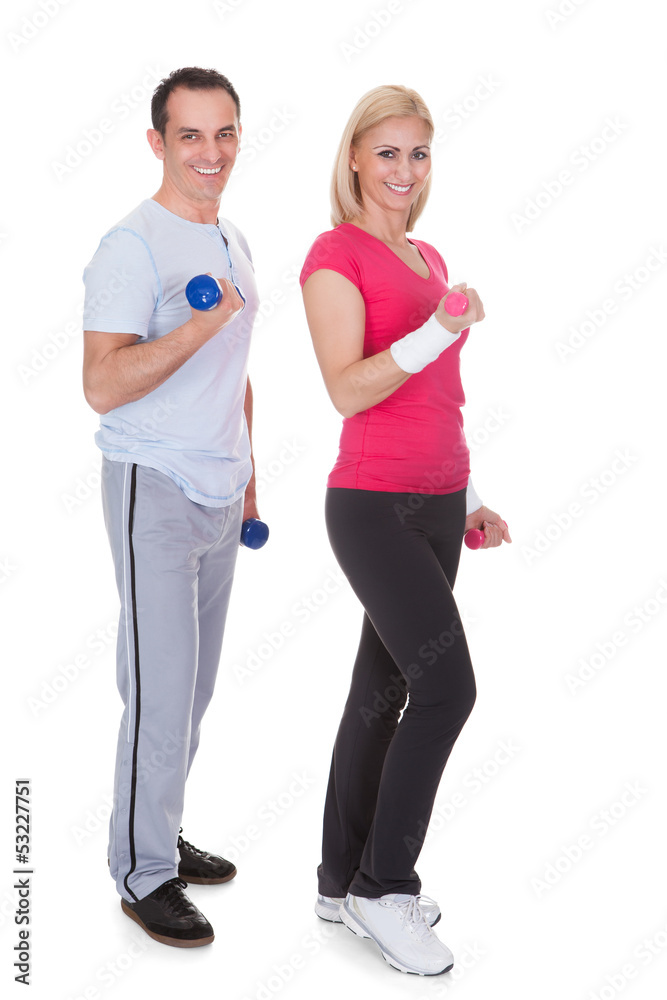 Portrait Of Couple Exercising With Dumbbells Portrait Of Couple Exercising With Dumbbells