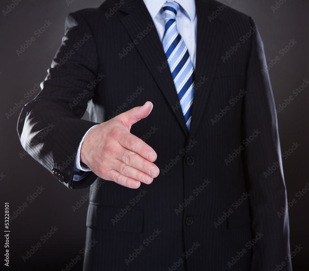 Close-up Of Businessman Offering Handshake