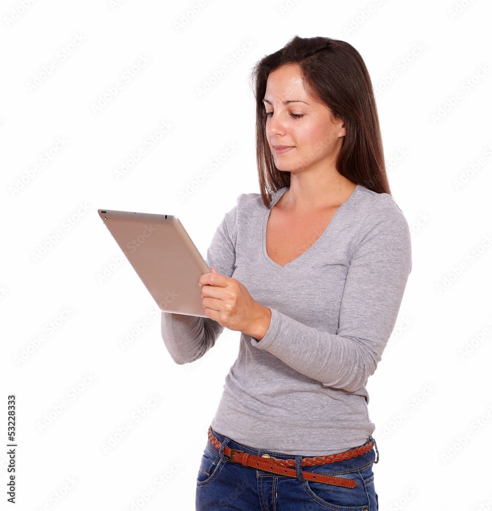 Charming woman working on tablet pc while standing Charming woman working on tablet pc while standing