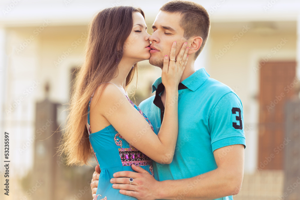 woman kisses boyfriend on street woman kisses boyfriend on street