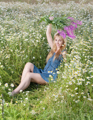 young woman with bouquet of firetop flower in the field.. photo