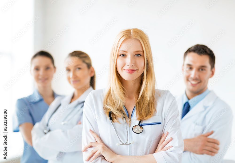 female doctor in front of medical group female doctor in front of medical group