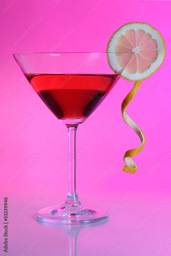 Red cocktail in martini glass on pink background Red cocktail in martini glass on pink background