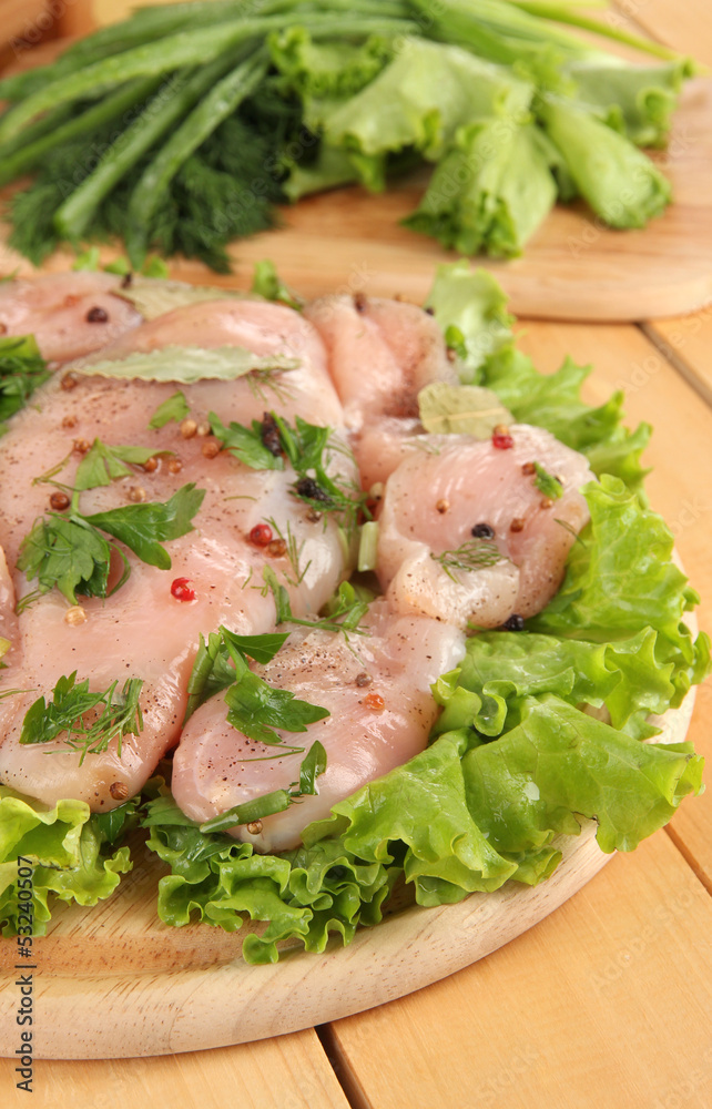 Chicken meat on wooden board,herbs and spices close-up Chicken meat on wooden board,herbs and spices close-up