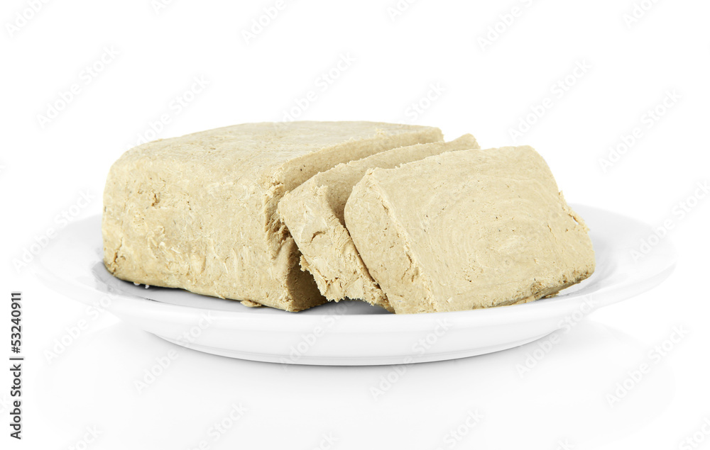 Tasty halva on plate isolated on white Tasty halva on plate isolated on white