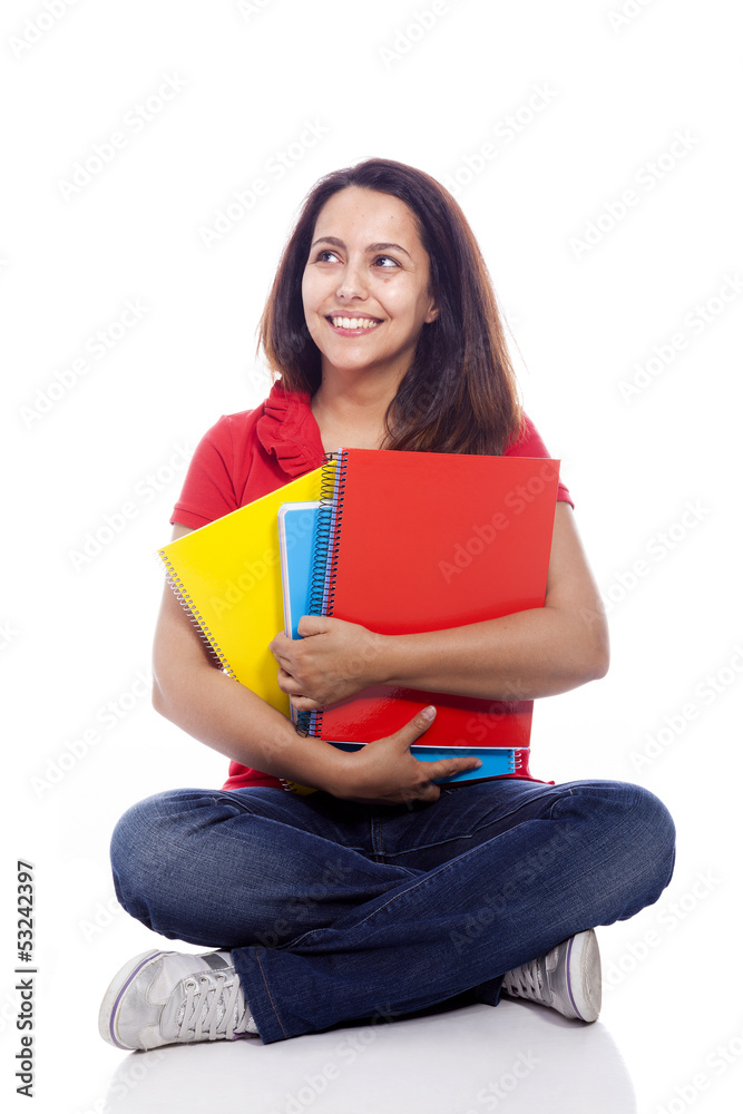 Happy female student sitting on floor with notebooks - isolated Happy female student sitting on floor with notebooks - isolated