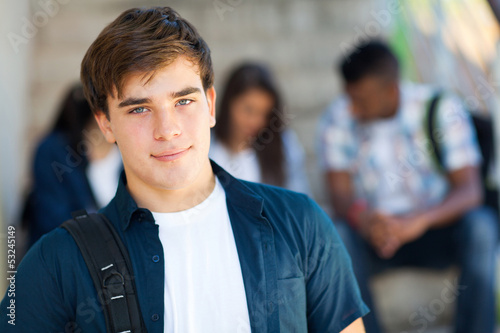 highschool boy with friends on background