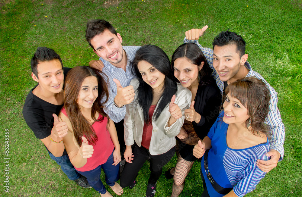 Fototapeta premium Group of teens thumbing up outdoors