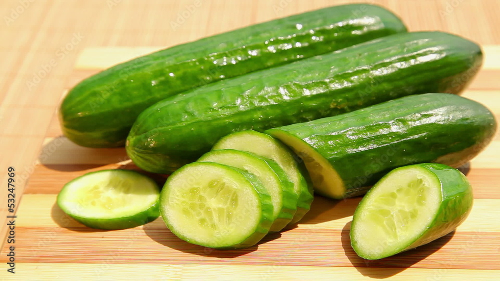 Cucumber on bamboo cutting board - dolly shot of cucumber Cucumber on bamboo cutting board - dolly shot of cucumber