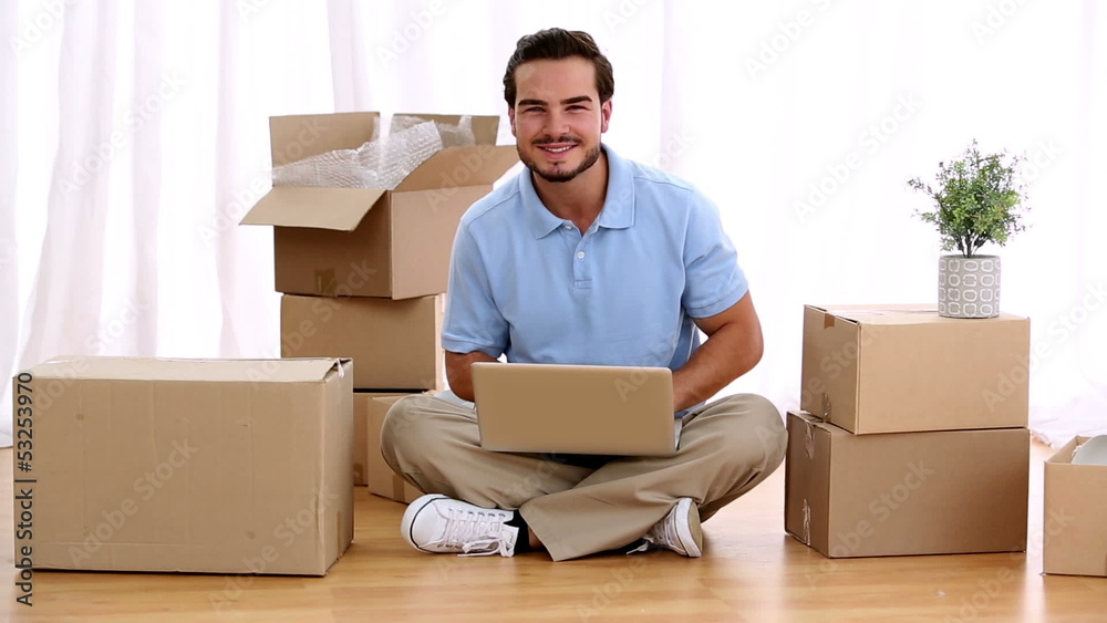 Man using his laptop in his living room Man using his laptop in his living room