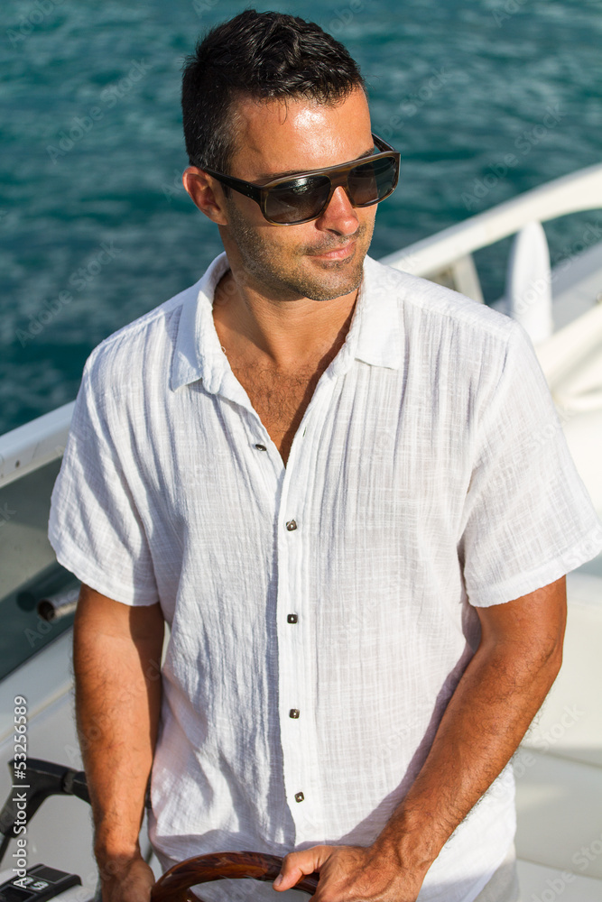 Handsome Young man on his yacht