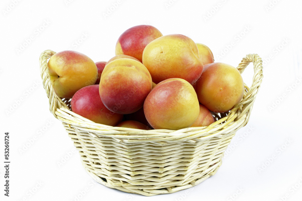 apricots in the basket on the White background apricots in the basket on the White background