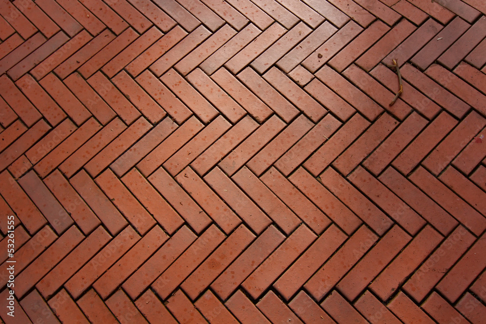 background made with red bricks in a herringbone background made with red bricks in a herringbone