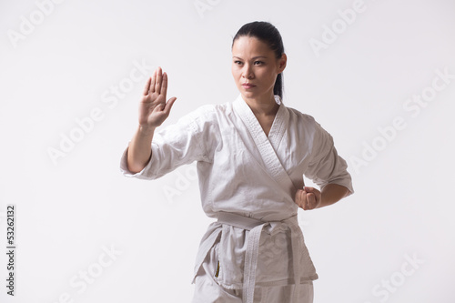 Φωτογραφία Beautiful woman in kimono show marshal art exercise on white
