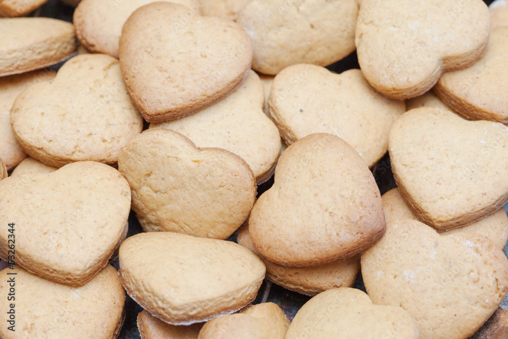 Lots of freshly baked heart shaped biscuits Lots of freshly baked heart shaped biscuits