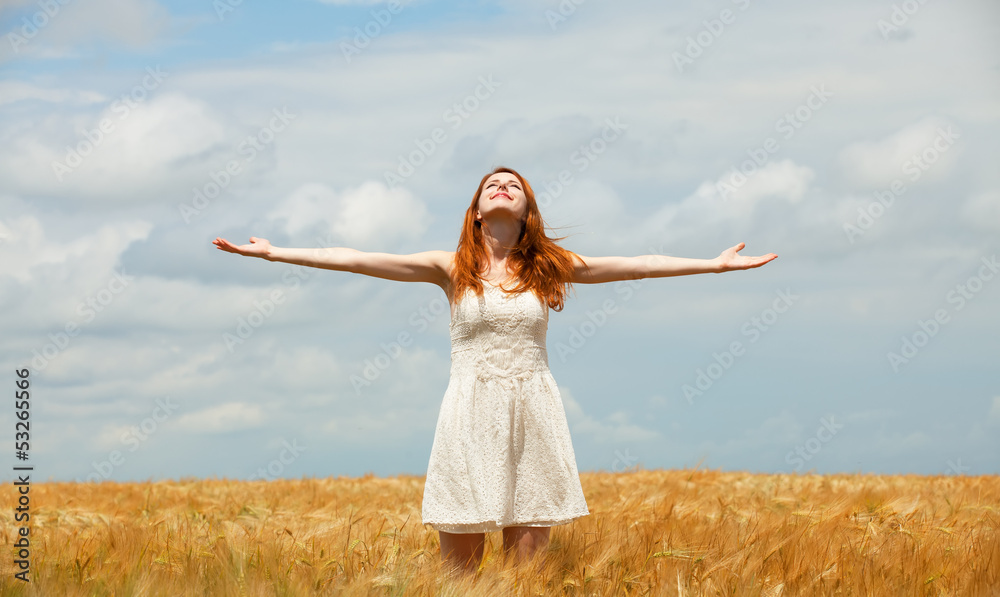 Redhead girl at wheat field