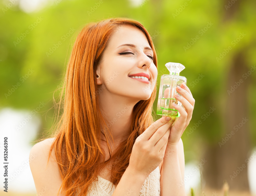 Redhead girl with perfume at outdoor