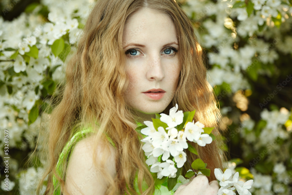 Beautiful young woman in summer garden