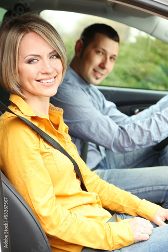Portrait of young beautiful  couple sitting in the car © Africa Studio