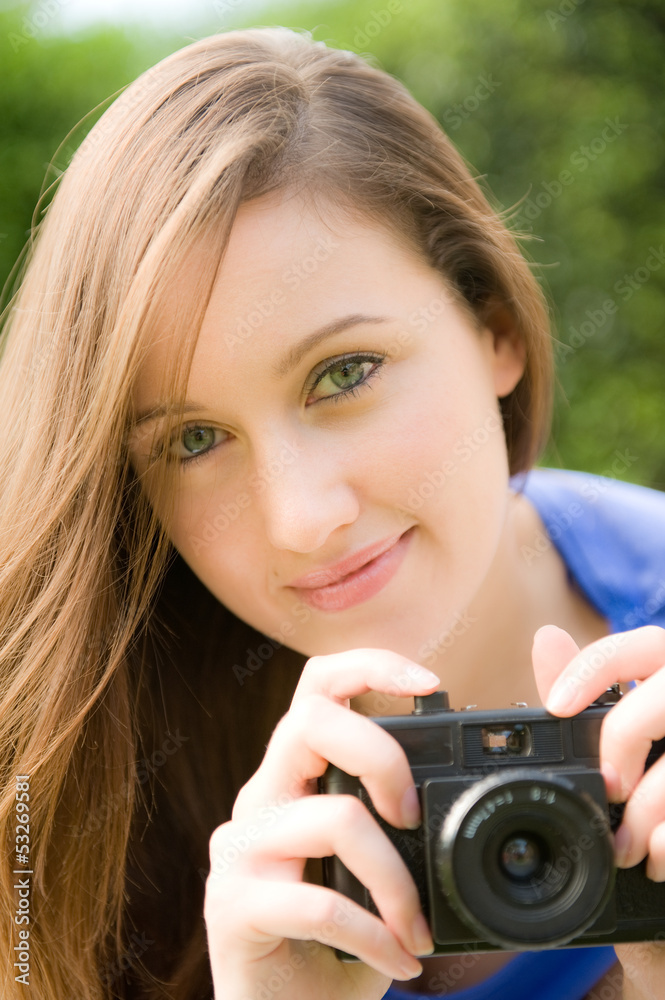 Young Woman With Camera Taking Photographs
