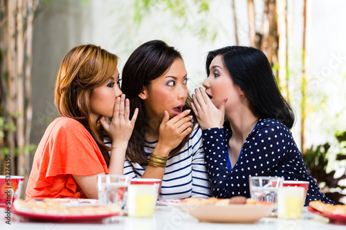 Asian women gossiping about things