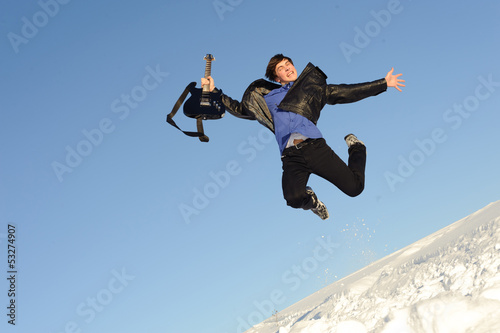 man with guitar jumping
