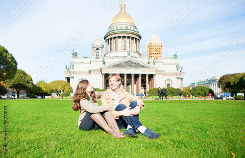 Couple on the grass near St. Isaac's cathedral photo