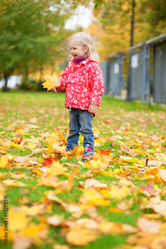 Adorable little girl enjoying beautiful fall day