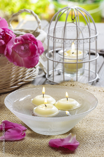 Floating candles in water  aromatic petals in the background