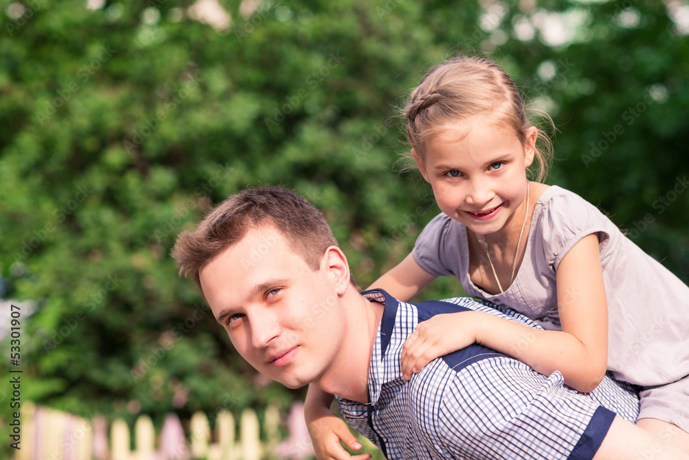 Happy father and daughter playing in the park Happy father and daughter playing in the park