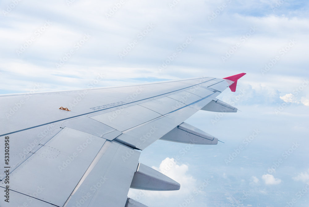 Wing of the plane on sky background - plane wing cloud patterns